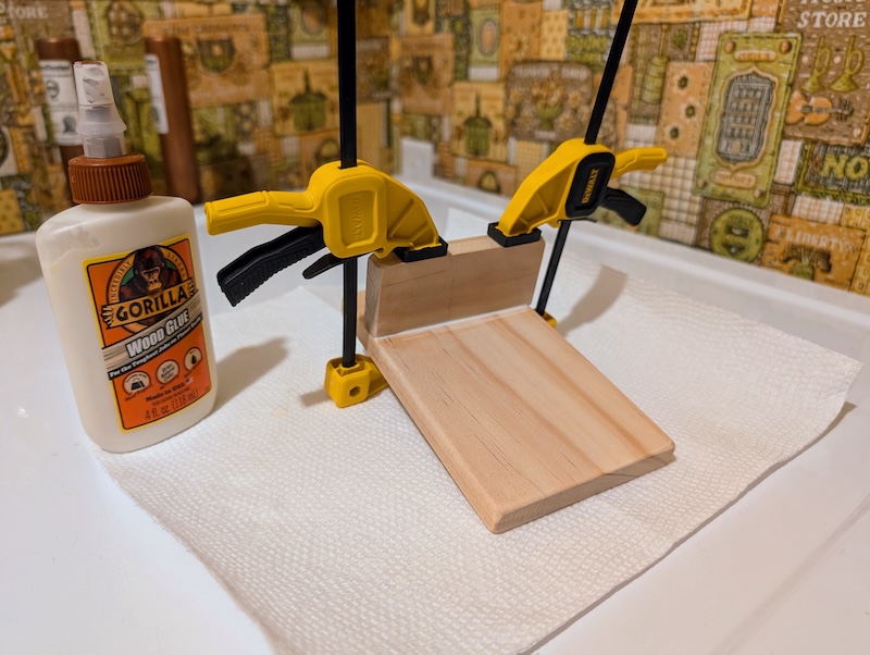 Wood boards glued and clamped together to make a coaster prototype