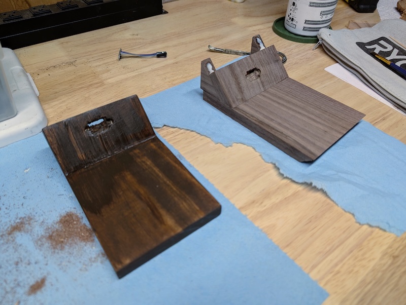A poorly stained pine coaster on the left and an unstained/un-oiled black walnut coaster on the right