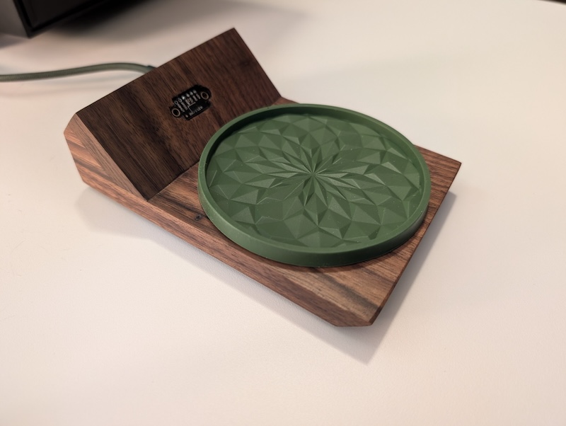 A nearly completed Smart Coaster made of black walnut with an exposed time-of-flight sensor in the back