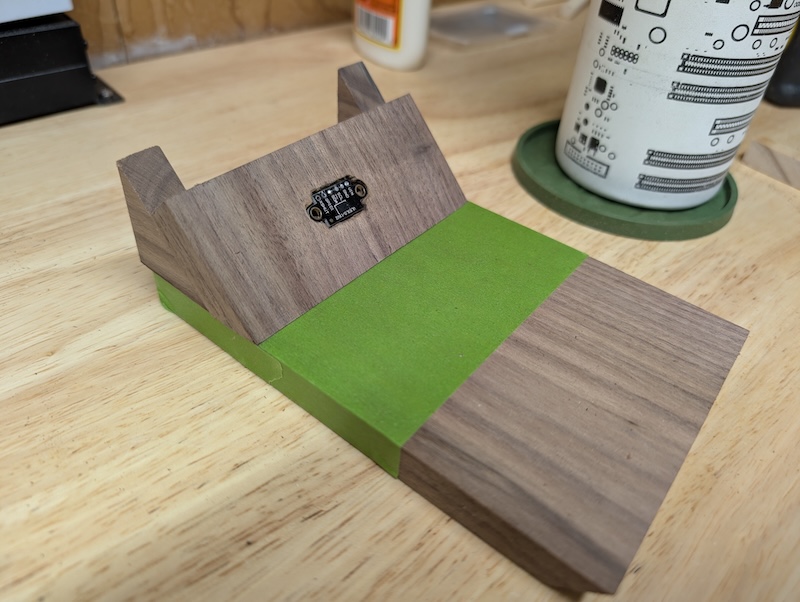 Green painter's tape covering the bare black